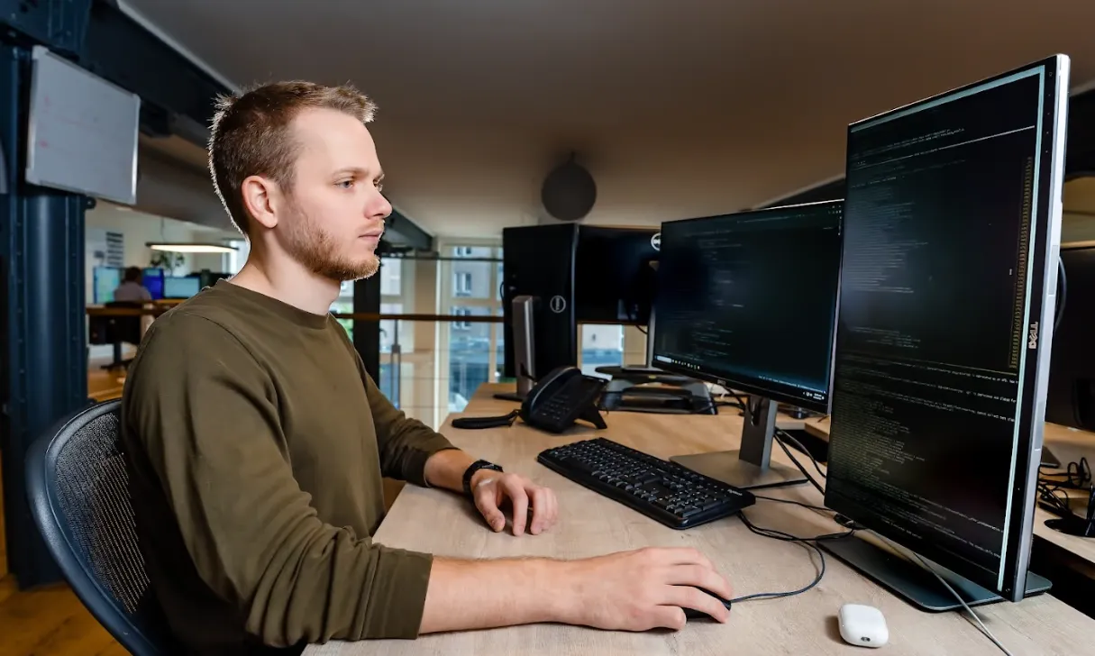 A desk with multiple monitors displaying trading software.